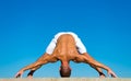 Yoga instructor with muscular body stretching. Sport and health care. Coach demonstrate yoga asana outdoors. Flexible