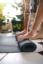 Yoga keeps you grounded. an unrecognisable man rolling up his yoga mat at home. Royalty Free Stock Photo