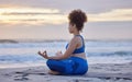 Yoga, lotus meditation and woman at beach at sunset for spiritual exercise, fitness or healthy body in summer. Padmasana Royalty Free Stock Photo