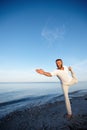 Yoga makes him feel alive. Full length shot of a handsome mature man doing yoga on the beach. Royalty Free Stock Photo