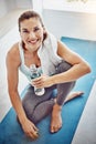 Yoga makes me a better person. Portrait of an attractive woman having water after her yoga session.