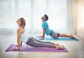 Yoga makes you feel more grounded and mindful. a couple practising yoga at home. Royalty Free Stock Photo