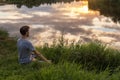 Yoga, man in lotus pose meditation, outdoors in nature, copy space