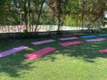 Yoga mat on green grass, close up photo, fitness concept