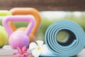 Yoga mat and kettlebell on table Royalty Free Stock Photo