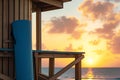 yoga mat propped against a wooden lifeguard tower, sunrise backdrop Royalty Free Stock Photo
