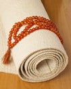 Yoga mat and rosaries Royalty Free Stock Photo