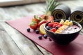 yoga mat with smoothie bowl and fruit for postworkout snack