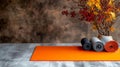 A yoga mat and two rolls of yoga mats on a wooden table Royalty Free Stock Photo