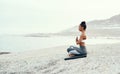 Yoga, medication and woman on a beach with lotus pose, wellness and fitness. Pilates, sea and female person on sand with Royalty Free Stock Photo