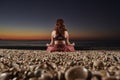 Yoga and meditation on calm beach at sunrise Royalty Free Stock Photo