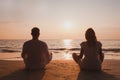 yoga and meditation in Goa, silhouette of man and woman at sunset, India Royalty Free Stock Photo