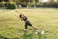 Yoga meditation online with laptop on the grass in green park. Fit girl training outdoor. Relaxation and meditating. Royalty Free Stock Photo