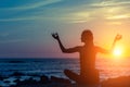 Yoga Meditation Silhouette. Woman on the ocean beach during amazing sunset. Royalty Free Stock Photo