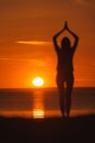 yoga meditation, silhouette of woman at sunset in pose tree with outstretched arms. Royalty Free Stock Photo