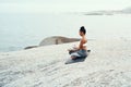 Yoga, meditation and woman on a beach with lotus pose, wellness and fitness. Pilates, sea and female person on sand with Royalty Free Stock Photo