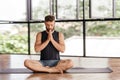 Yoga men workout in studio in front of a window