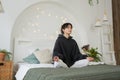 Yoga mindfulness meditation. Young healthy woman practicing yoga in bedroom at home. Woman sitting in lotus pose on bed Royalty Free Stock Photo