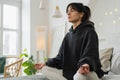 Yoga mindfulness meditation. Young healthy woman practicing yoga in bedroom at home. Woman sitting in lotus pose on bed Royalty Free Stock Photo