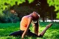 Yoga. mixed race woman practicing yoga or dancing or stretching in nature at park. Health lifestyle concept