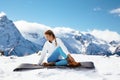 Yoga on mountain in winter Royalty Free Stock Photo