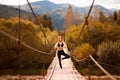 Calm woman doing yoga balance exercises. Yoga meditation on bridge over river with mountains background. Concept of Royalty Free Stock Photo