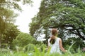 Yoga outdoors in public park. Asian woman sits in lotus position Royalty Free Stock Photo