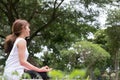 Yoga outdoors in public park. Asian woman sits in lotus position Royalty Free Stock Photo