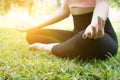 Yoga outdoors in summer park. young woman sits in lotus position Royalty Free Stock Photo