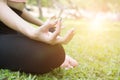 Yoga outdoors in summer park. young woman sits in lotus position Royalty Free Stock Photo