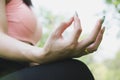 Yoga outdoors in summer park. young woman sits in lotus position Royalty Free Stock Photo