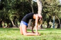 Yoga - outdoors young beautiful slender woman yoga instructor doing camel pose Ustrasana asana exercise outdoors. Royalty Free Stock Photo