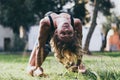 Yoga - outdoors young beautiful slender woman yoga instructor doing camel pose Ustrasana asana exercise outdoors. Royalty Free Stock Photo