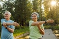 Yoga at park. Senior family couple exercising outdoors. Royalty Free Stock Photo