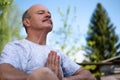 Yoga at park. Senior man with mustache with namaste sitting.Concept of calm and meditation. Royalty Free Stock Photo