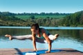 Yoga. Pose Tittibhasana. Beautiful girl doing handstand on the background of beautiful nature Royalty Free Stock Photo