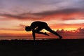 Yoga Poses. Woman Practicing Cat Stretch Asana On Ocean Beach. Female Silhouette Standing In Marjariasana Pose At Beautiful Sunset Royalty Free Stock Photo