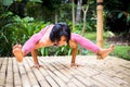 Yoga practice outdoor. Asian yoga teacher practicing Titibasana, Firefly pose. Strong core, arm balance. Yoga retreat. Self care,