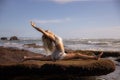 Yoga practice. Slim Caucasian woman practicing Hanumanasana, Monkey Pose or Front Split. One arm rasied up. Hamstrings stretching