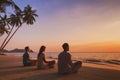 yoga retreat on beach at sunset, silhouettes of group of people meditating Royalty Free Stock Photo
