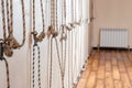 Yoga ropes hanging on empty studio wall. Iyengar yoga concept Royalty Free Stock Photo