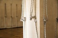 Yoga ropes hanging on empty studio wall. Iyengar yoga