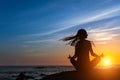 Yoga silhouette meditation woman on the Sea beach during amazing sunset. Royalty Free Stock Photo