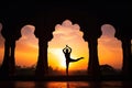 Yoga silhouette in old temple at sunset sky background. Royalty Free Stock Photo