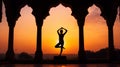 Yoga silhouette in old temple at sunset sky background. Royalty Free Stock Photo