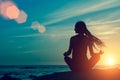 Yoga silhouette of woman in Lotus position on a rock seaside meditation Royalty Free Stock Photo