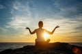 Yoga silhouette young woman doing fitness exercises on the beach at sunset Royalty Free Stock Photo