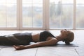 Yoga still girl laying on sport mat, relaxing after exercising