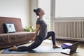 Yoga student doing online video lesson at home