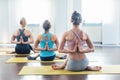 Yoga students in class showing a hero pose variation